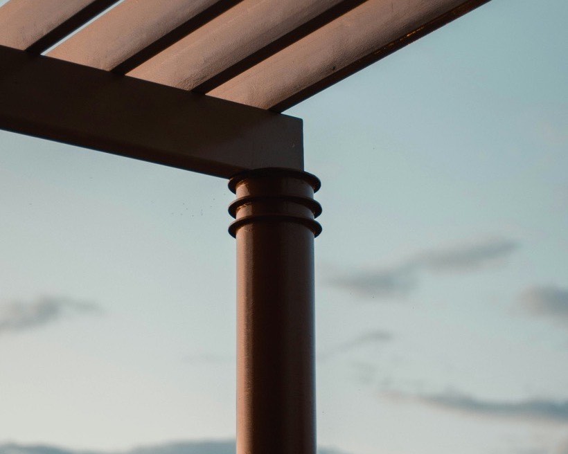 Pergola rafters against an evening sky